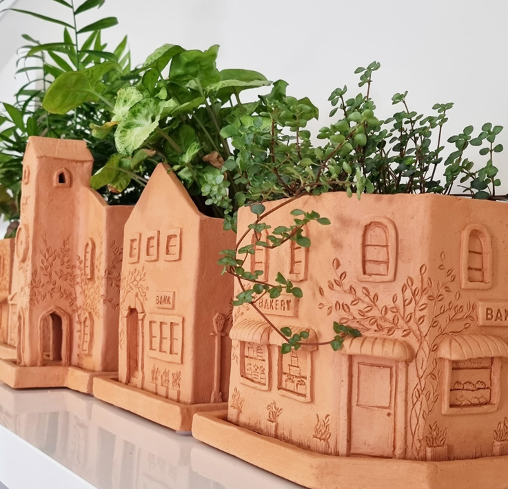 terracotta plant pots shaped like buildings